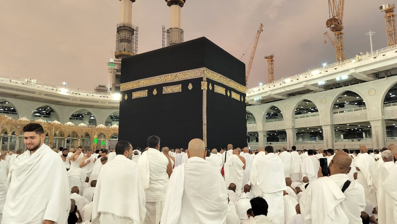 Pilgrims dressed in white gather around the Kaaba in Mecca's Grand Mosque, Saudi Arabia.